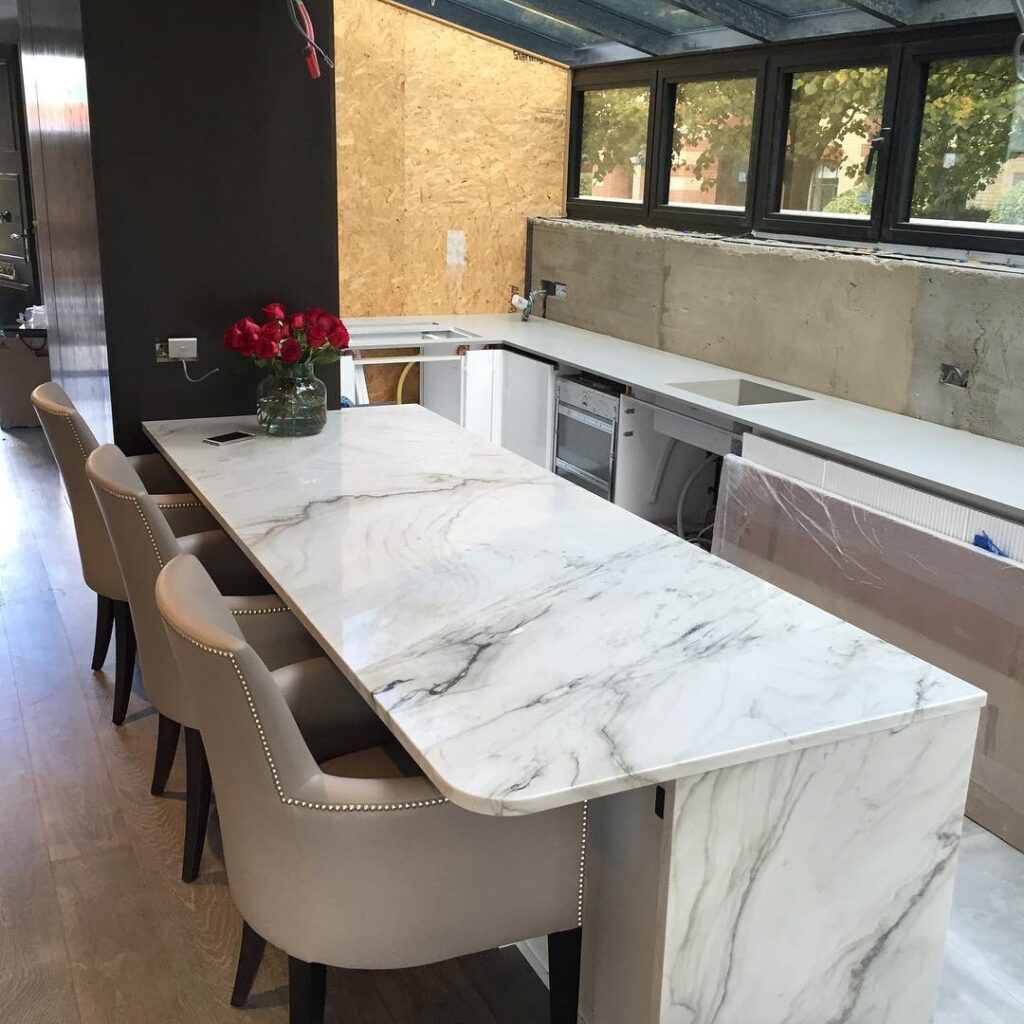 Stone countertop fabrication workshop showing polished slab finishing